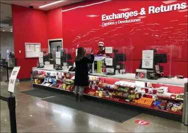  ?? DAVID ZALUBOWSKI — THE ASSOCIATED PRESS ?? A customer is shown at the exchanges and return counter in a Target department store early Wednesday, in Glendale, Colo.