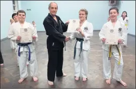  ??  ?? Instructor Pat Shawcroft (centre) pictured with students at the latest grading session this month.
