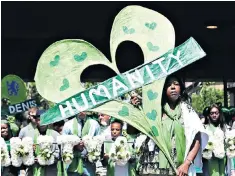  ??  ?? Clarrie Mendy, who lost two relatives in the fire, leads a procession to the tower yesterday