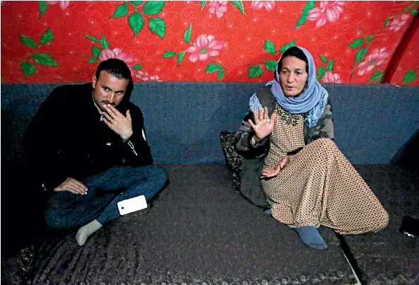  ?? AP ?? Baseh Hammo, a Yazidi woman who escaped enslavemen­t by Islamic State group militants, sits with a relative in a camp for displaced people outside Dahuk, Iraq. Yazidi women enslaved by IS who escaped captivity say there could be hundreds of other women still missing, women who may never return home.