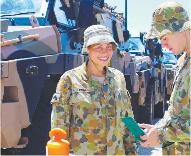  ?? Private Jamila Opia and Private Jason Mithchell of the 3rd Combat Service Support Battalion make final preparat base last weekend. ??