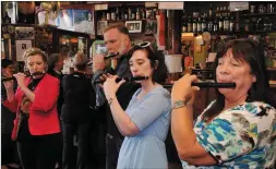  ??  ?? Tradfest organisers Aoife and Deirdre Granville playing a tune in O’Flaherty’s pub with members of the Loch a Bhogaidh fife band from Baile Bhúirne.