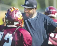  ?? STAFF PHOTO BY TROY STOLT ?? Tyner Academy assistant coach Antwon McClain speaks with a player during practice on Monday.