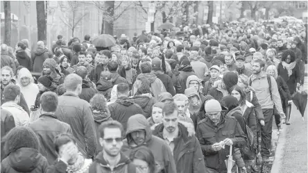  ??  ?? French expats wait in line to vote in the French presidenti­al election in Montreal on Saturday.