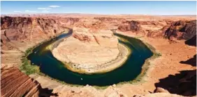  ?? AP PHOTO/BRITTANY PETERSON, FILE ?? The Colorado River flows at Horseshoe Bend in Glen Canyon National Recreation Area on June 8 in Page, Ariz. Arizona water officials are concerned about getting water in the future from the Colorado River as its levels decline.