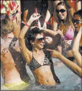  ?? Las Vegas Review-Journal ?? Partiers play in the Palms pool as rapper Lupe Fiasco performs during filming for “MTV Spring Break” in 2011.