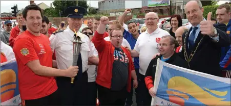  ??  ?? Conor Mc Auley , Supt Andrew Watters, Sean Carolan and Mayor Pio Smith with members of the Drogheda Special Olympics Club at the arrival of the Special Olympics flame of hope at the club