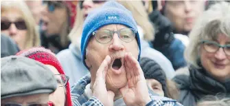  ??  ?? A man shouts during a demonstrat­ion outside Bombardier's head office in Montreal Sunday to protest recent pay hikes and bonuses to the company's top executives.