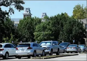  ?? NWA Democrat-Gazette/ANDY SHUPE ?? Cars sit Friday in Lot 71 on the University of Arkansas campus in Fayettevil­le. A planned change to a new system of parking enforcemen­t has been delayed, forcing the university to continue issuing permit decals for the coming academic year.