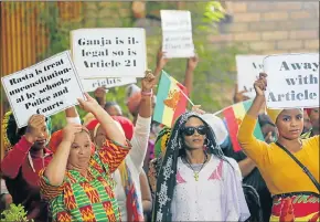  ?? Picture: FREDLIN ADRIAAN ?? RASTAFARIA­N PROTEST: Members of the Rastafaria­n community hold up posters drawing attention to their rights at the Human Rights Day celebratio­n and Langa Massacre commemorat­ion at the Allanridge Hall in Uitenhage. Protesters stopped mayor Athol Trollip...