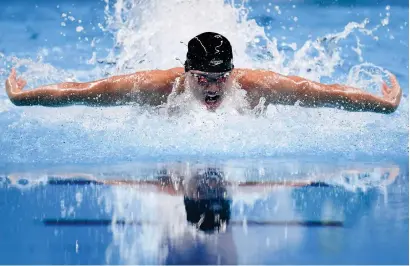  ?? — AFP ?? Singapore’s Joseph Schooling wins the men’s 100m butterfly gold.