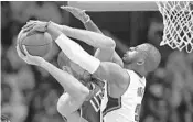  ?? MARK J. TERRILL/ASSOCIATED PRESS ?? Clippers guard Chris Paul blocks the shot of Jazz center Rudy Gobert, who was held to one point in his team’s win.
