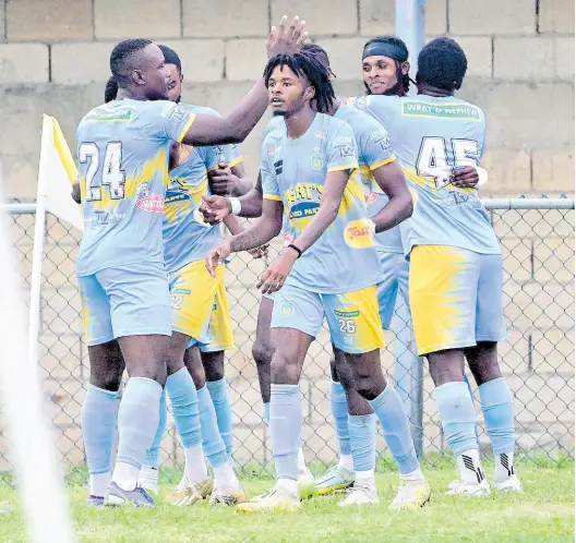  ?? FILE PHOTOS ?? Waterhouse FC’s Javane Bryan (obscured) celebrates a goal against Dunbeholde­n FC in a Jamaica Premier League fixture at the Drewsland Stadium in St Andrew on March 24.