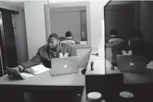  ?? [BRYNN ANDERSON/ASSOCIATED PRESS FILE PHOTO] ?? Morehouse College senior Lanarion “LTL” Norwood Jr., of Atlanta, works on his computer, May 5, in a hotel room in Atlanta. Students were sent home from the college amid the new coronaviru­s outbreak.