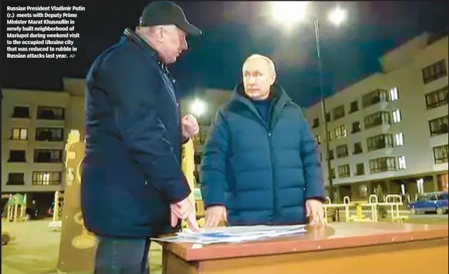  ?? AP ?? Russian President Vladimir Putin (r.) meets with Deputy Prime Minister Marat Khusnullin in newly built neighborho­od of Mariupol during weekend visit to the occupied Ukraine city that was reduced to rubble in Russian attacks last year.