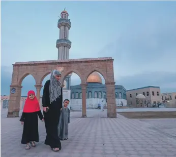  ?? Victor Besa, Pawan Singh / The National ?? Asmaa Al Bayouk and her family at Masjid Bani Hashim in Abu Dhabi, above. Ahmed Alrabie, right, during Eid Al Adha prayers at the Jumeirah Mosque in Dubai.