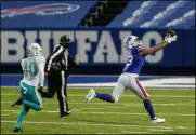  ?? JOHN MUNSON - THE ASSOCIATED PRESS ?? Buffalo Bills wide receiver Gabriel Davis (13) catches a pass before running in a touchdown against Miami Dolphins defensive back Nik Needham (40) in the second half of an NFL football game, Sunday, Jan. 3, 2021, in Orchard Park, N.Y.