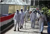  ?? — PRITAM BANDYOPADH­YAY ?? Health workers sanitise an area near Nizamuddin mosque on Wednesday.