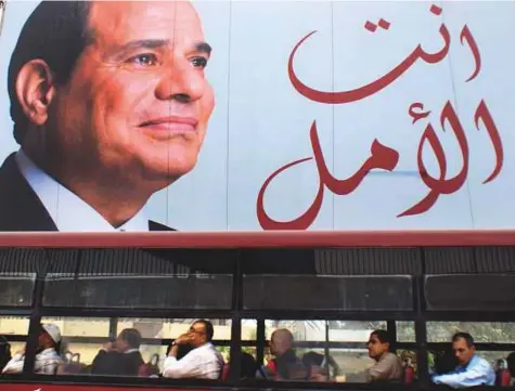  ?? AP ?? A bus passes an election banner for Al Sissi in Arabic that reads, “You are the hope’, in Cairo on Wednesday.