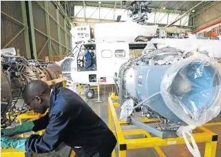  ?? /Kevin Sutherland ?? Diversifie­d arms maker: A mechanic works on an Oryx helicopter engine in a workshop hangar on the Denel Aviation site in Boksburg. Closing Denel would be catastroph­ic, the writer says.