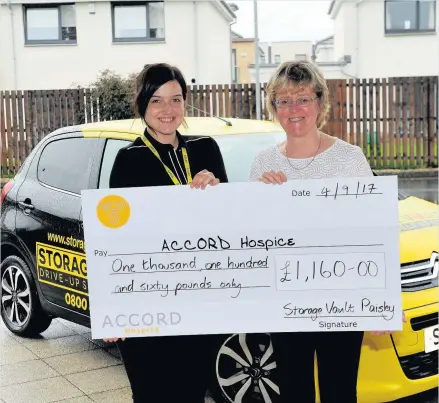  ??  ?? Cheque it out Natalie Kerr (left) Storage Vault regional manager, hands over a cheque to Alison Patrick of Accord