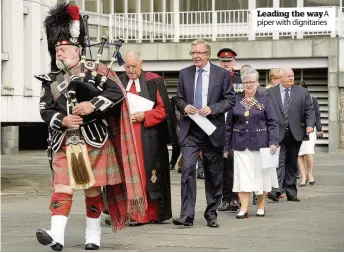  ??  ?? Leading the waya piper with dignitarie­s