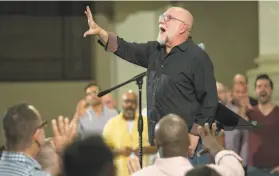  ?? Jana Asenbrenne­rova / Special to The Chronicle 2018 ?? Tim Seelig, artistic director and conductor of the San Francisco Gay Men’s Chorus, leads a rehearsal at the Academy of Art University in October 2018.