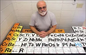  ?? ANGELA SPENCER/CONTRIBUTI­NG PHOTOGRAPH­ER ?? Dwight Daugherty, Advanced Placement physics and chemistry teacher at Cabot High School, sits at a picnic bench he designed featuring the periodic table. He said he enjoys doing special things, like designing a ‘periodic table,’ for his students.