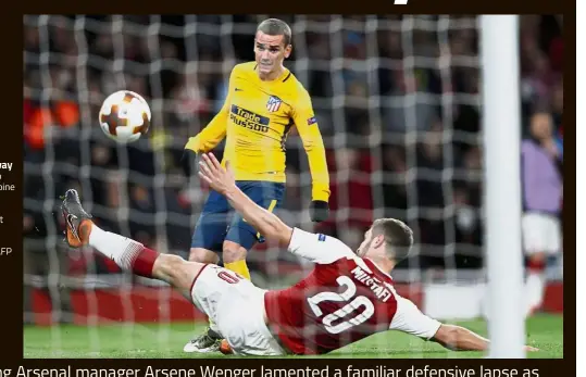  ?? — AFP ?? Precious away goal: Atletico Madrid’s Antoine Griezmann scoring the equaliser past Arsenal’s Shkodran Mustafi.