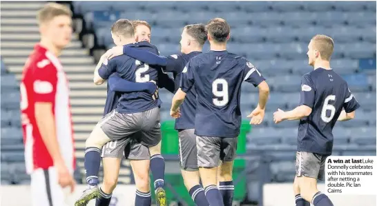  ??  ?? A win at lastLuke Donnelly celebrates with his teammates after netting a double. Pic Ian Cairns