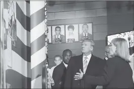  ?? SUSAN WALSH — THE ASSOCIATED PRESS ?? President Donald Trump, center, listens to Museum Division Director Lucy Allen, right, during a tour of the newly opened Mississipp­i Civil Rights Museum in Jackson, Mississipp­i, on Saturday. Housing and Urban Developmen­t Secretary Ben Carson, left,...