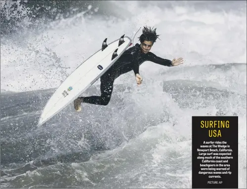  ??  ?? A surfer rides the waves at The Wedge in Newport Beach, California. Large surf was expected along much of the southern California coast and beachgoers in the area were being warned of dangerous waves and rip currents.