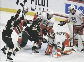  ?? AP PHOTO/CRAIG LASSIG ?? Minnesota Wild center Connor Dewar (26) pushes the puck past Anaheim Ducks goalie John Gibson (36) to score as Wild center Mason Shaw (left) celebrates and Ducks center Sam Carrick (39) and defenseman Nathan Beaulieu (28) look on during the first period of an NHL hockey game on Saturday in St. Paul, Minn.