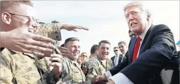  ?? Carolyn Kaster Associated Press ?? TROOPS GREET President Trump as he arrives at Harrisburg Internatio­nal Airport en route to the Pennsylvan­ia rally. He is the first president to skip the Washington dinner since Reagan after being shot in 1981.