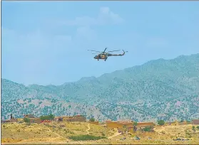  ?? AFP ?? A Taliban helicopter flies over an affected area in Bernal district, Paktika province, on Thursday.
