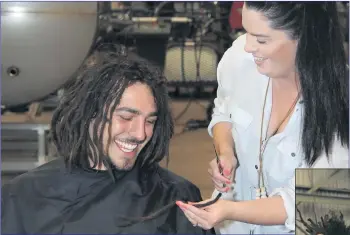  ??  ?? HAIR IT GOES: Hairdresse­r Cassie Mackley starts to cut off Torri Moore’s dreadlocks for his World’s Greatest Shave campaign at Horsham Hydraulics on Friday. Below: A ‘fresh’ feeling Torri Moore grips his locks. Pictures: GEORGIA BAILEY