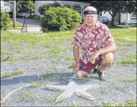  ?? LYNN CURWIN/TRURO NEWS ?? James Shand puts the finishing touches on a star he’s adding to the labyrinth on the grounds of Brunswick Street United Church.