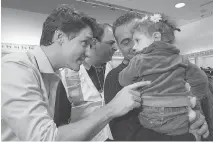  ?? NATHAN DENETTE/THE CANADIAN PRESS ?? Prime Minister Justin Trudeau greets refugees fleeing the Syrian civil war, at Pearson Internatio­nal Airport, in Toronto in 2015. Canada should be helping Rohingya Muslims fleeing Myanmar just as it did Syrian refugees, writes Themrise Khan.