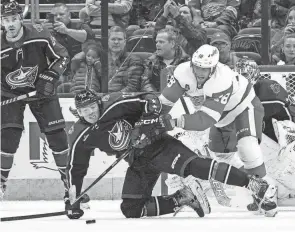  ?? JOSEPH SCHELLER/COLUMBUS DISPATCH ?? Blue Jackets defenseman Jake Christians­en attempts to block a Detroit shot attempt on Dec. 4.