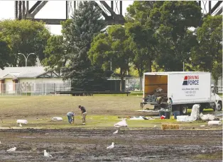  ?? IAN KUCERAK ?? Crews continue to clean up the Chaos AB music festival site at Kinsmen Park on Monday.