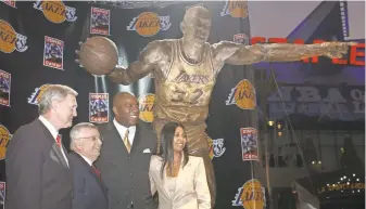  ??  ?? From left, Jerry West, David Stern, Earvin “Magic” Johnson and wife Cookie Johnson gather at the 2004 unveiling of a Johnson statue in front of Staples Center in Los Angeles.