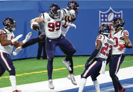  ?? Brett Coomer / Staff photograph­er ?? Texans defensive ends J.J. Watt (99) and Charles Omenihu (94) jump in celebratio­n afterWatt intercepte­d a pass and ran it back for a touchdown in the first quarter of the Texans’ 41-25 win over the Detroit Lions on Thursday.