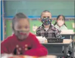  ?? JAE C. HONG — THE ASSOCIATED PRESS ?? Kindergart­en students sit in their classroom on April 13, the first day of in-person learning at Maurice Sendak Elementary School in Los Angeles.