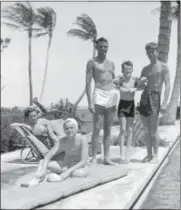  ?? KENNEDY FAMILY COLLECTION — JOHN F. KENNEDY LIBRARY FOUNDATION
VIA AP ?? In this October 1936photo provided by the Kennedy Family Collection, courtesy of the John F. Kennedy Library Foundation, John F. Kennedy, right, Robert F. Kennedy, second from right, and Patricia Kennedy, front left, pose with friends in Palm Beach, Fla. The Bostonbase­d museum completed an 18-month project in 2018 to catalog and digitize more than 1,700black-and-white Kennedy family snapshots that are viewable online, giving a nation still obsessed with “Camelot” a candid new glimpse into their everyday lives.