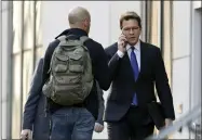  ?? TONY DEJAK—ASSOCIATED PRESS ?? Mark Lanier, right, an attorney for the plaintiffs, enters the U.S. Federal courthouse, Monday, Oct. 21, 2019, in Cleveland. The nation’s three dominant drug distributo­rs and a big drugmaker have reached a tentative deal to settle a lawsuit related to the opioid crisis just as the first federal trial over the crisis was due to begin Monday, according to a lead lawyer for the local government­s suing the drug industry.