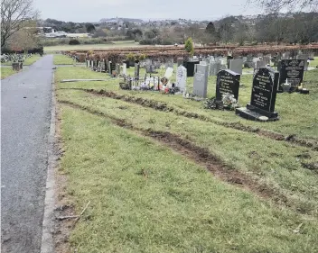  ??  ?? ABOVE: The damage caused to Woodlands cemetery in February. BELOW: A mud-spattered gravestone after the incident.