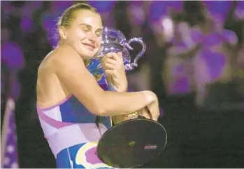  ?? DITA ALANGKARA AP ?? Aryna Sabalenka hugs the Daphne Akhurst Memorial Trophy after winning Australian Open title.