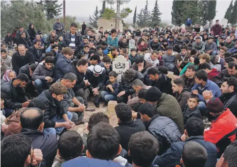 ?? AFP ?? Mourners at the funeral of Raed Fares, below, and Hammoud Al Jneid in the village of Kafranbel in Idlib yesterday