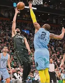  ?? Brian Fluharty / Getty Images ?? Boston’s Derrick White shoots over Memphis’ Xavier Tillman during the Celtics’ 119-109 home win over the Grizzlies on Sunday. White led Boston with 23 points.