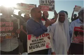  ?? (UAL) ?? MK MASOUD GNAIM (center) participat­es in a protest against the killing of his Rohingya Muslim ‘brothers’ in Myanmar, outside the country’s embassy in Tel Aviv Monday.